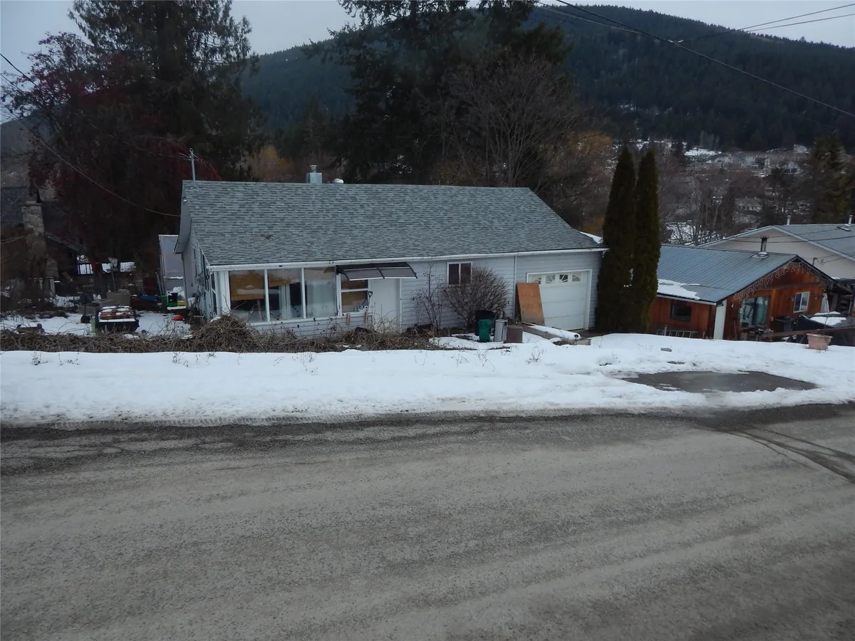 An older, neglected bungalow on a snowy Creston lot